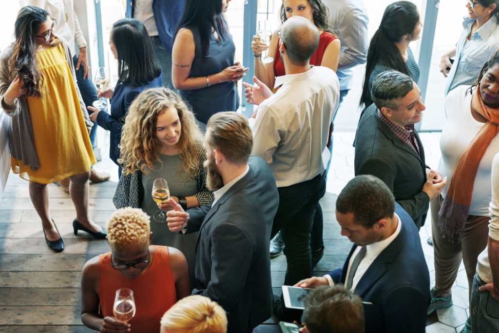 Group of women and men at reception social with wine - overhead view